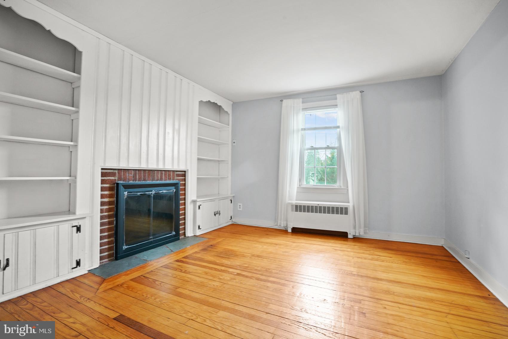 919 Valley Forge Road, Unit 1 Phoenixville, PA 19460 - Photo 8 of 25 a view of empty room with wooden floor and fireplace