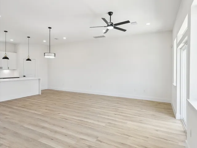 a bedroom with a bed a couch and a potted plant