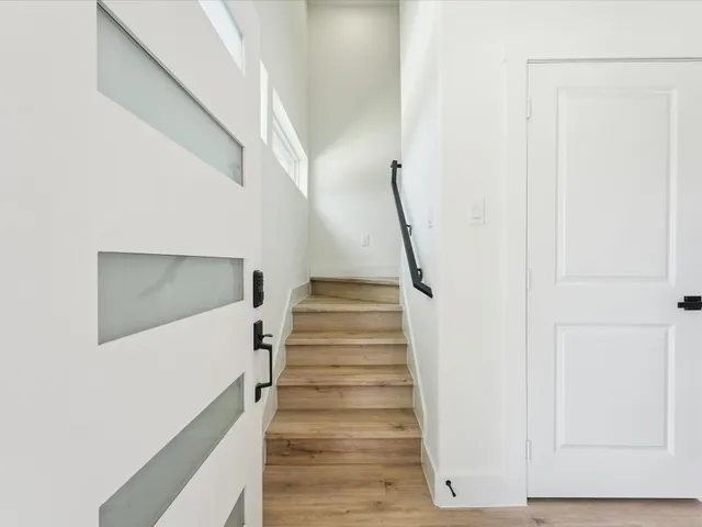 a kitchen with a sink and a stove top oven with wooden floor