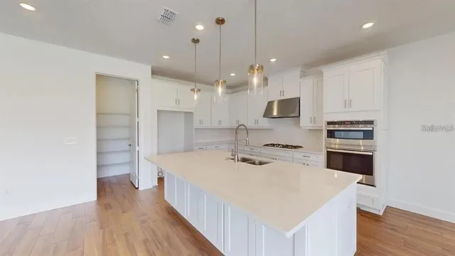 a kitchen with a stove a sink and a refrigerator