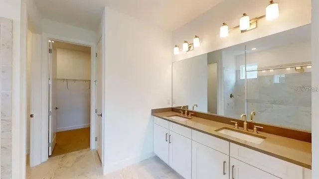 a bathroom with a sink and a large mirror