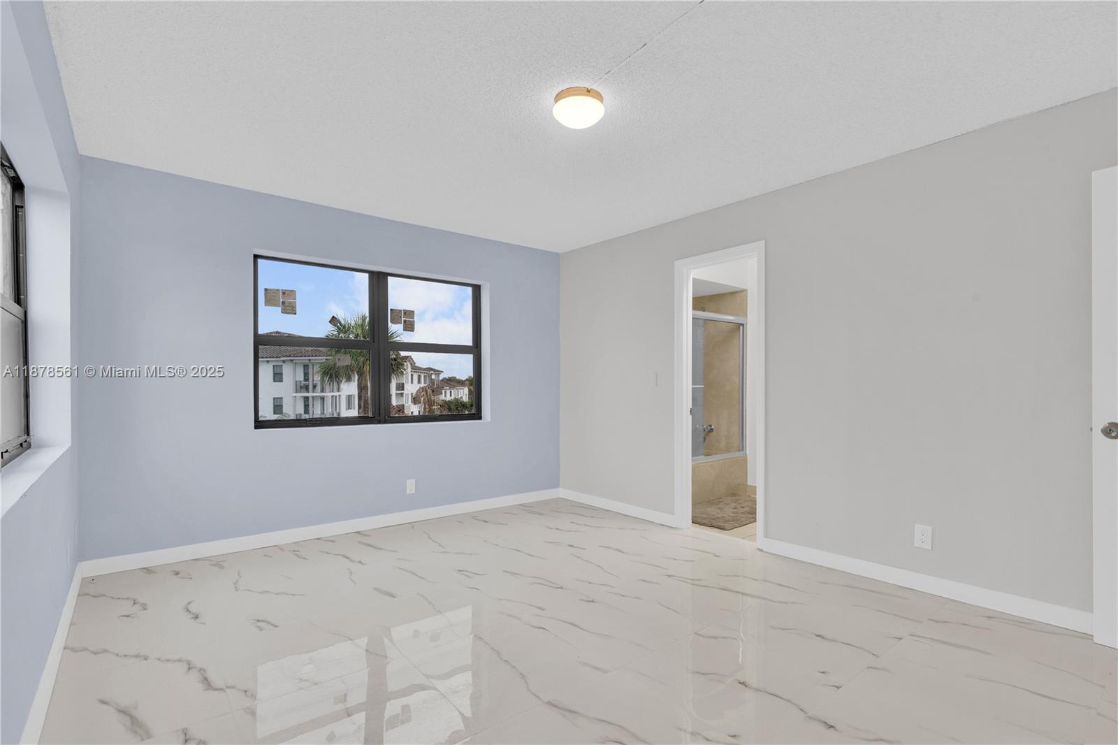9355 Southwest 8th Street, Unit 425 Boca Raton, FL 33428 - Photo 17 of 42 an empty room with window and ceiling fan