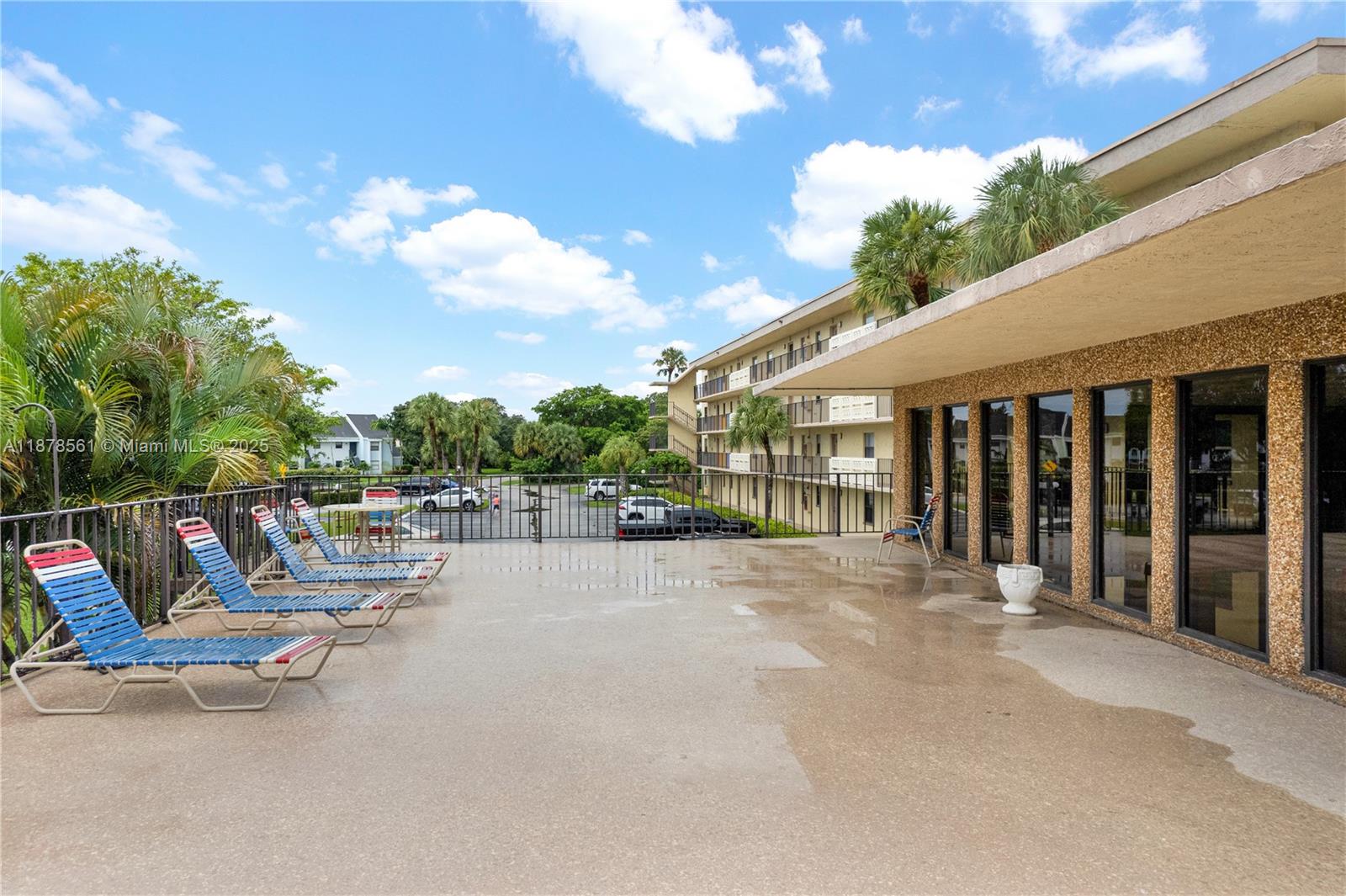 9355 Southwest 8th Street, Unit 425 Boca Raton, FL 33428 - Photo 34 of 42 a view of a patio with a table and chairs and couches