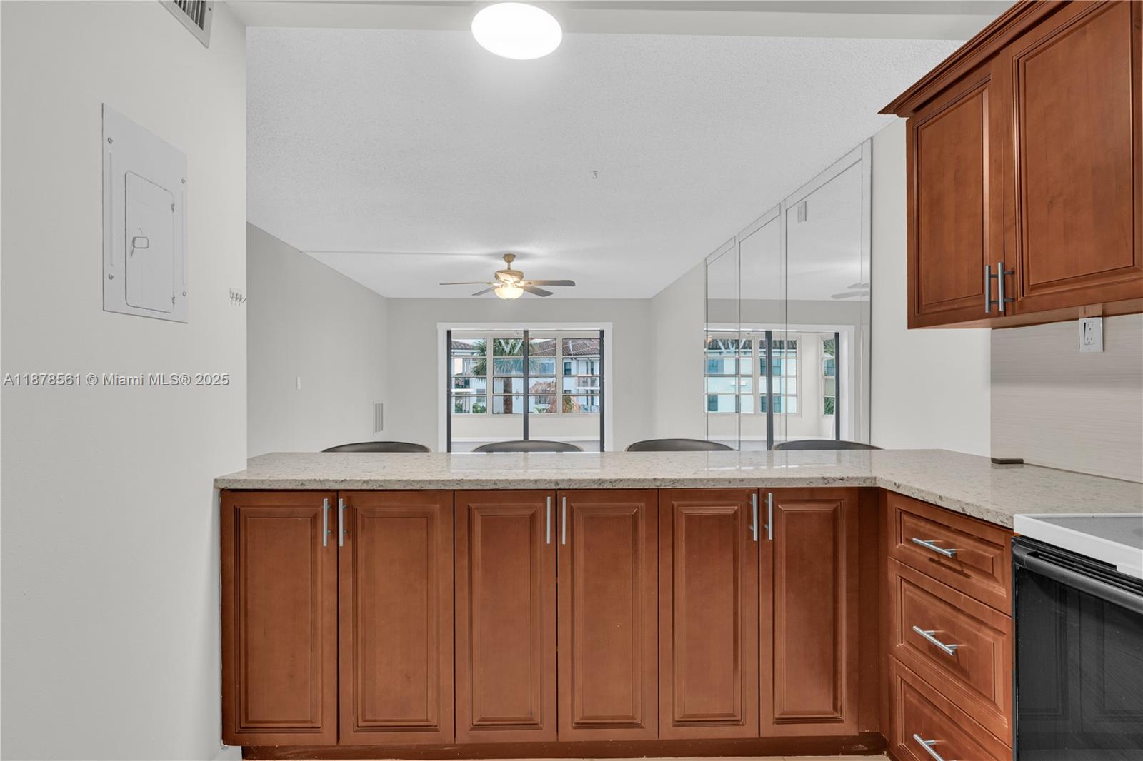 9355 Southwest 8th Street, Unit 425 Boca Raton, FL 33428 - Photo 9 of 42 a kitchen with stainless steel appliances granite countertop wooden cabinets a sink and dishwasher