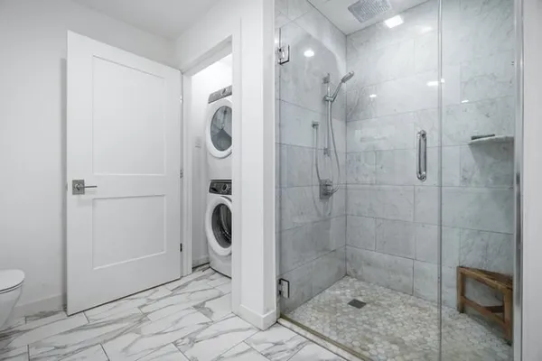 a bathroom with a shower and toilet