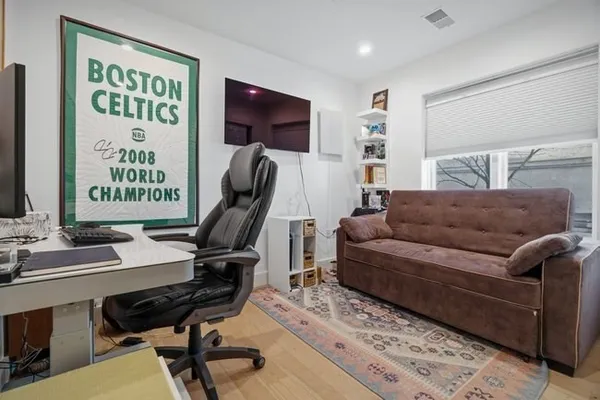 a living room with furniture a projector and screen