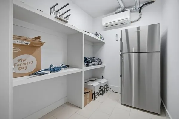 a kitchen with a refrigerator and a stove