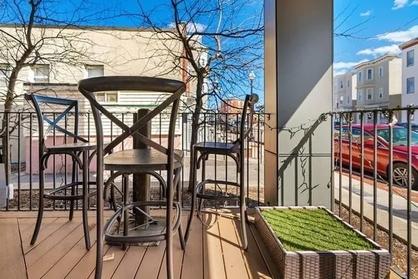 a backyard of a house with barbeque oven table and chairs