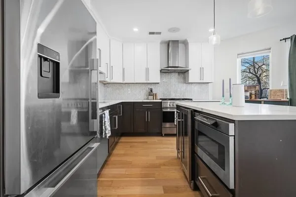a kitchen with stainless steel appliances granite countertop a stove a sink and a refrigerator
