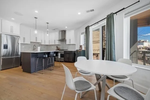 a large kitchen with a table and chairs