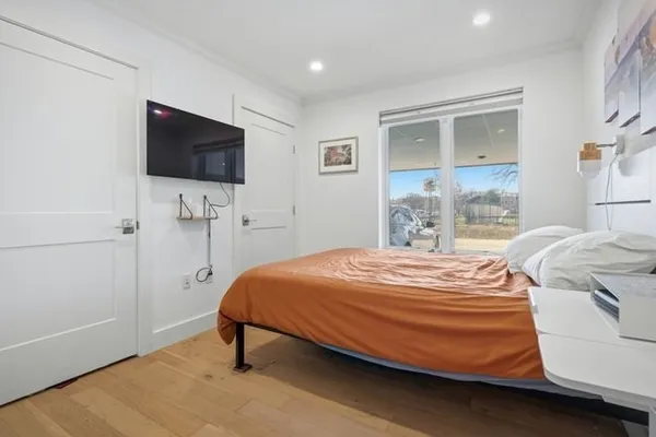 a bedroom with a bed and a flat screen tv