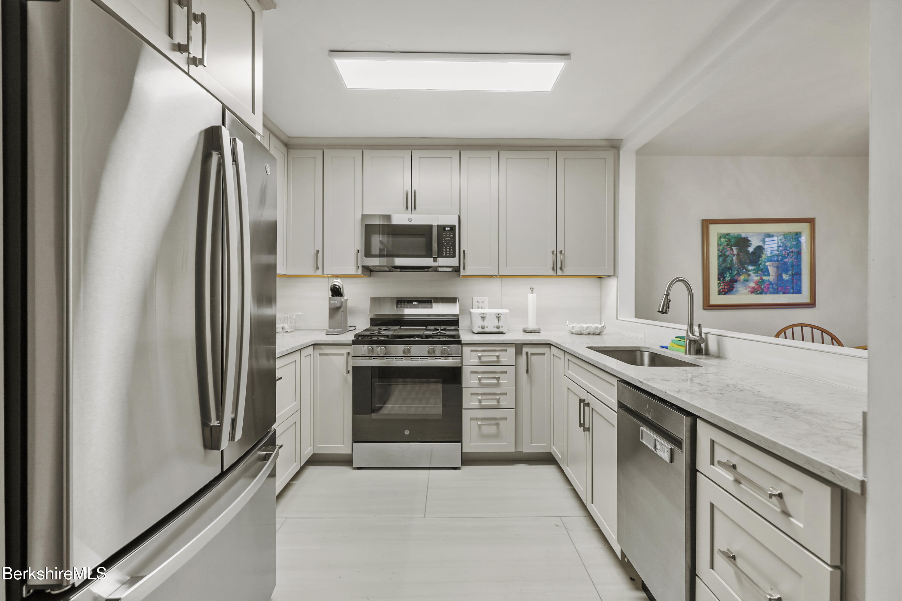 1136 Barker Road, Unit 27 Pittsfield, MA 01201 - Photo 12 of 30 a kitchen with stainless steel appliances granite countertop a refrigerator sink and stove