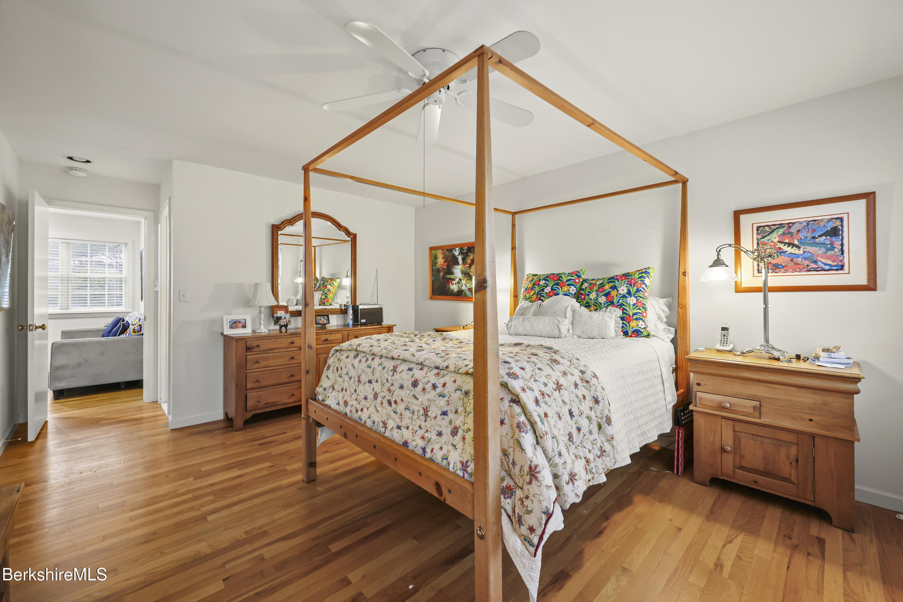 1136 Barker Road, Unit 27 Pittsfield, MA 01201 - Photo 17 of 30 a bedroom with a large bed and a chandelier