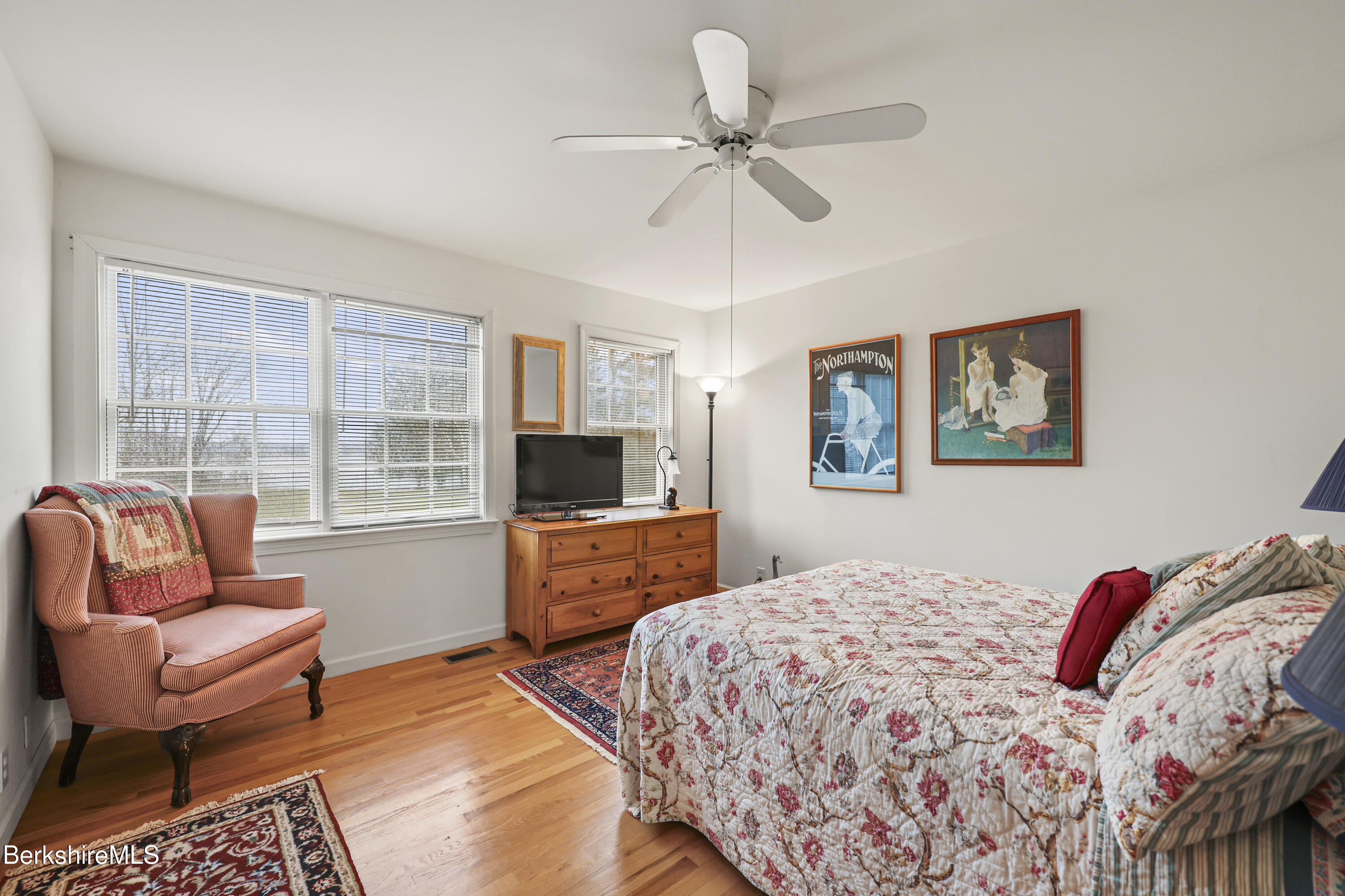 1136 Barker Road, Unit 27 Pittsfield, MA 01201 - Photo 20 of 30 a bedroom with a bed a couch and a flat screen tv