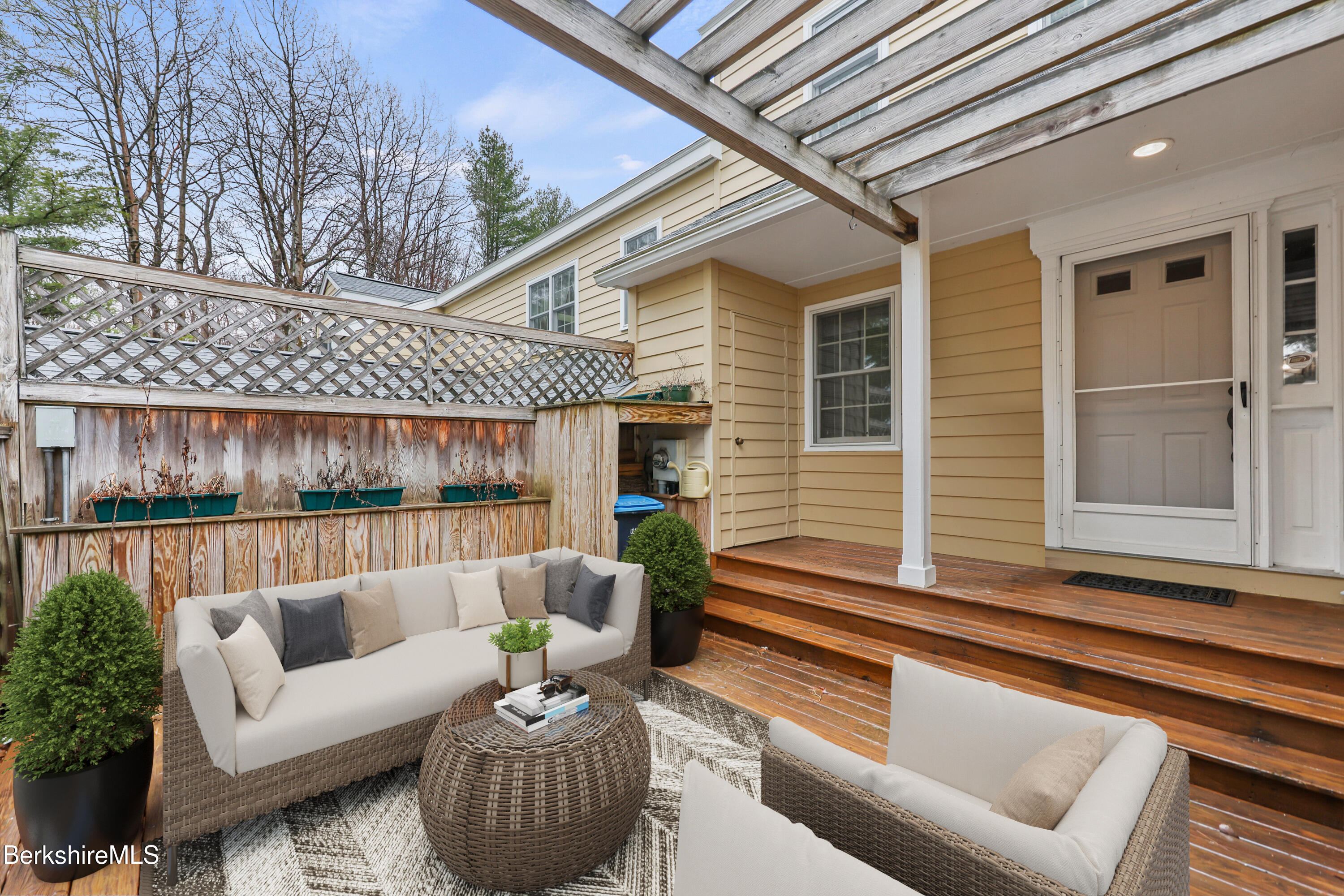 1136 Barker Road, Unit 27 Pittsfield, MA 01201 - Photo 2 of 30 a view of a patio with couches chairs and wooden floor