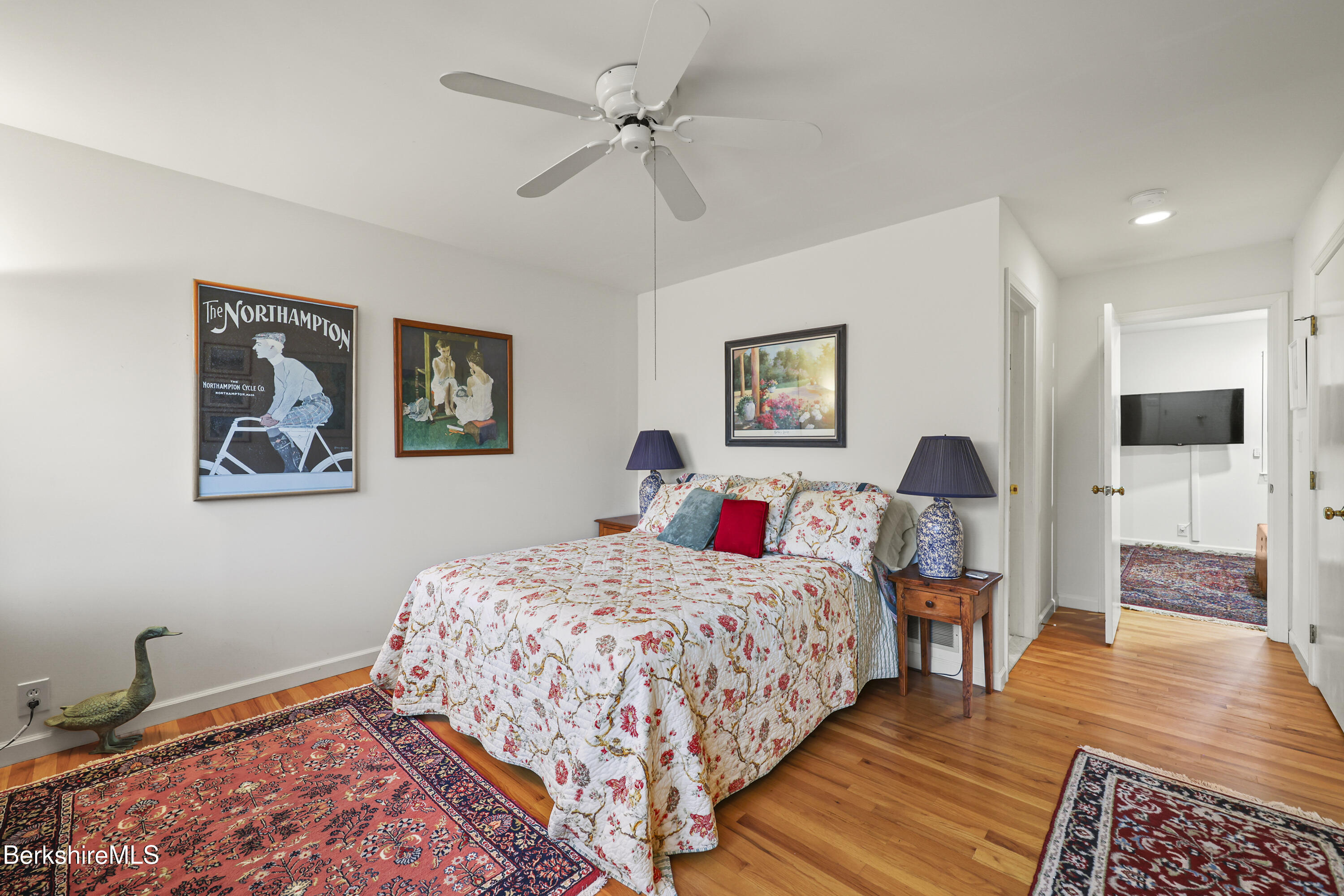 1136 Barker Road, Unit 27 Pittsfield, MA 01201 - Photo 21 of 30 a bedroom with a bed and wooden floor