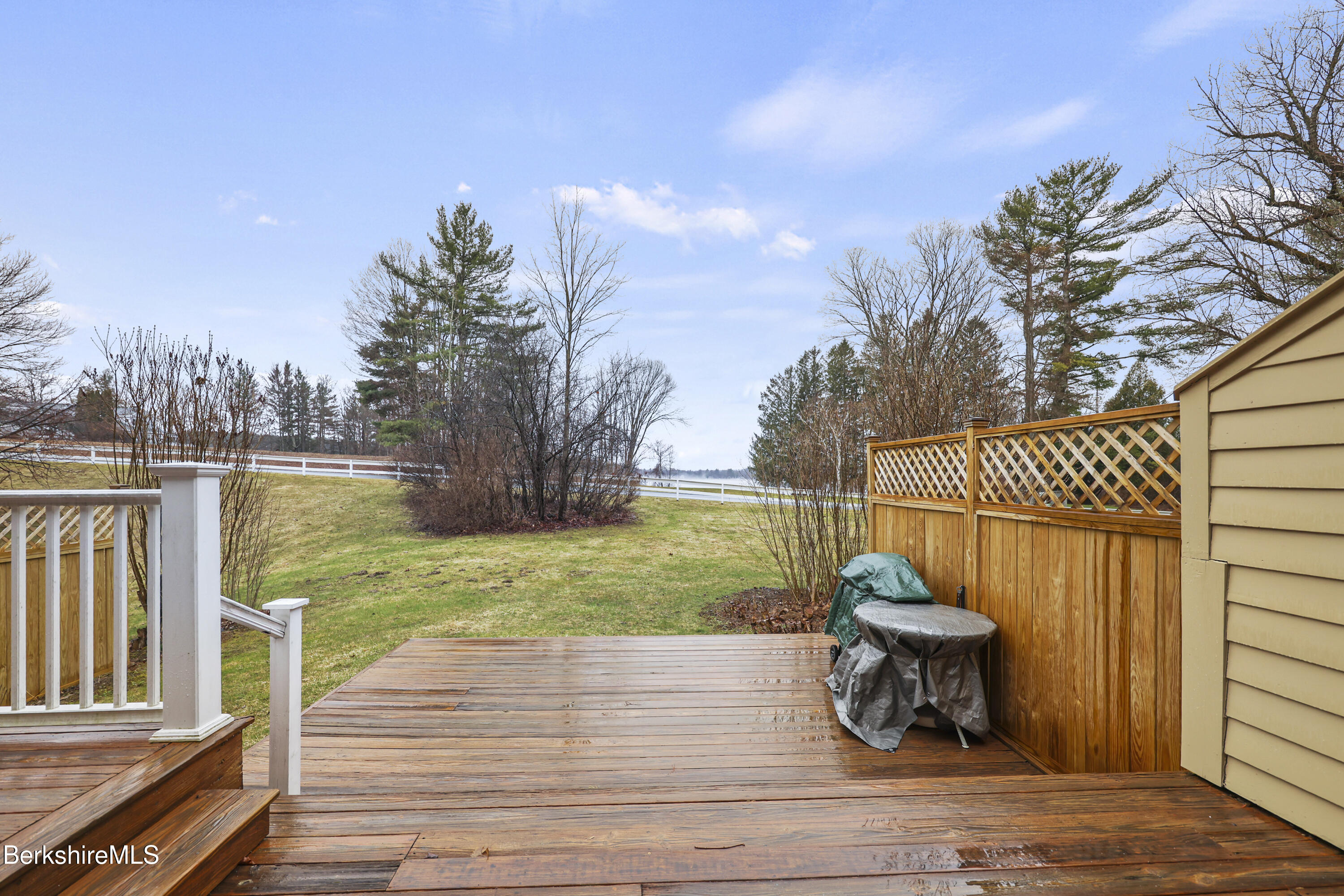 1136 Barker Road, Unit 27 Pittsfield, MA 01201 - Photo 24 of 30 a view of a deck with chair and wooden floor