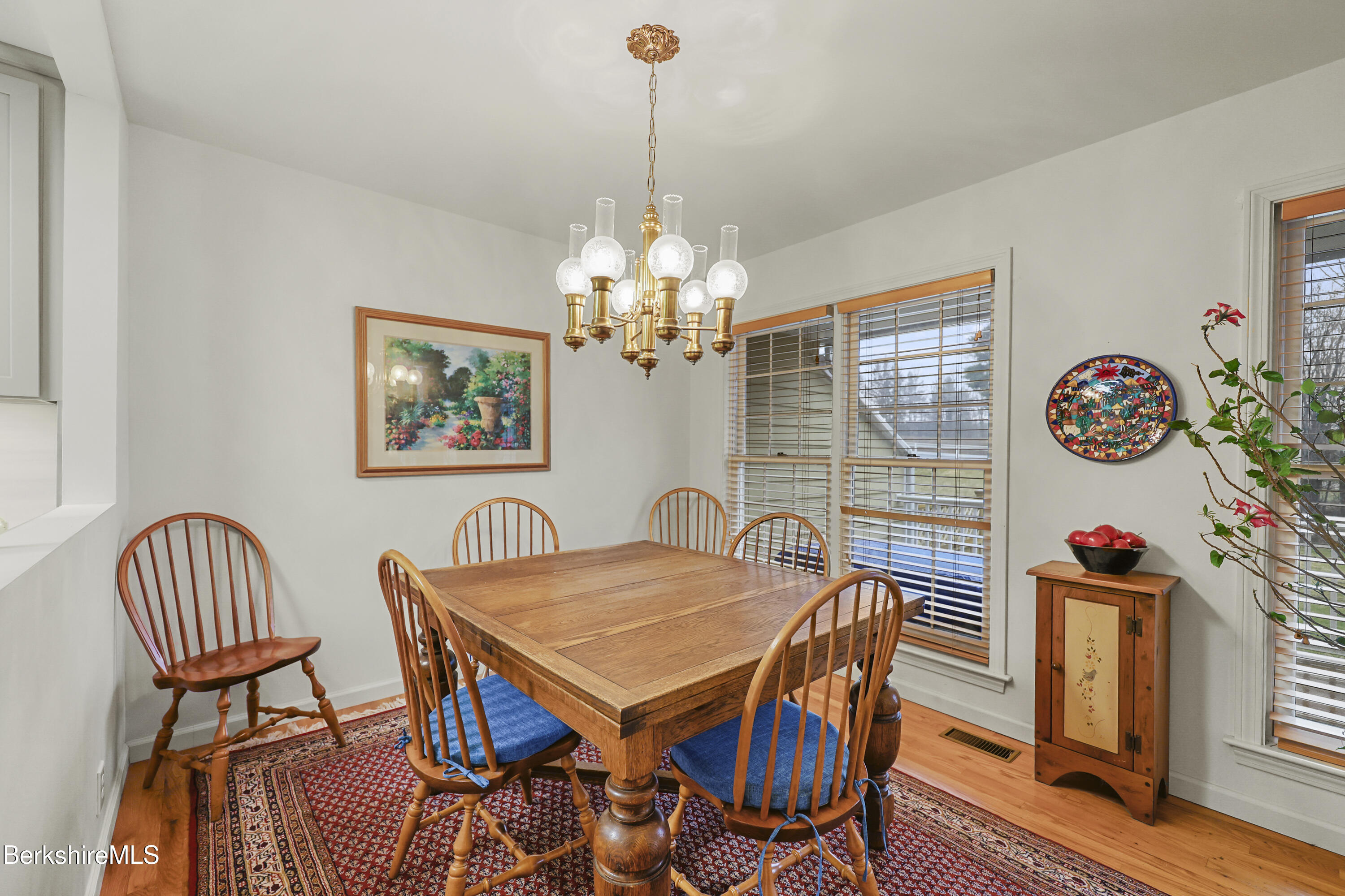 1136 Barker Road, Unit 27 Pittsfield, MA 01201 - Photo 7 of 30 a view of a dining room with furniture and chandelier
