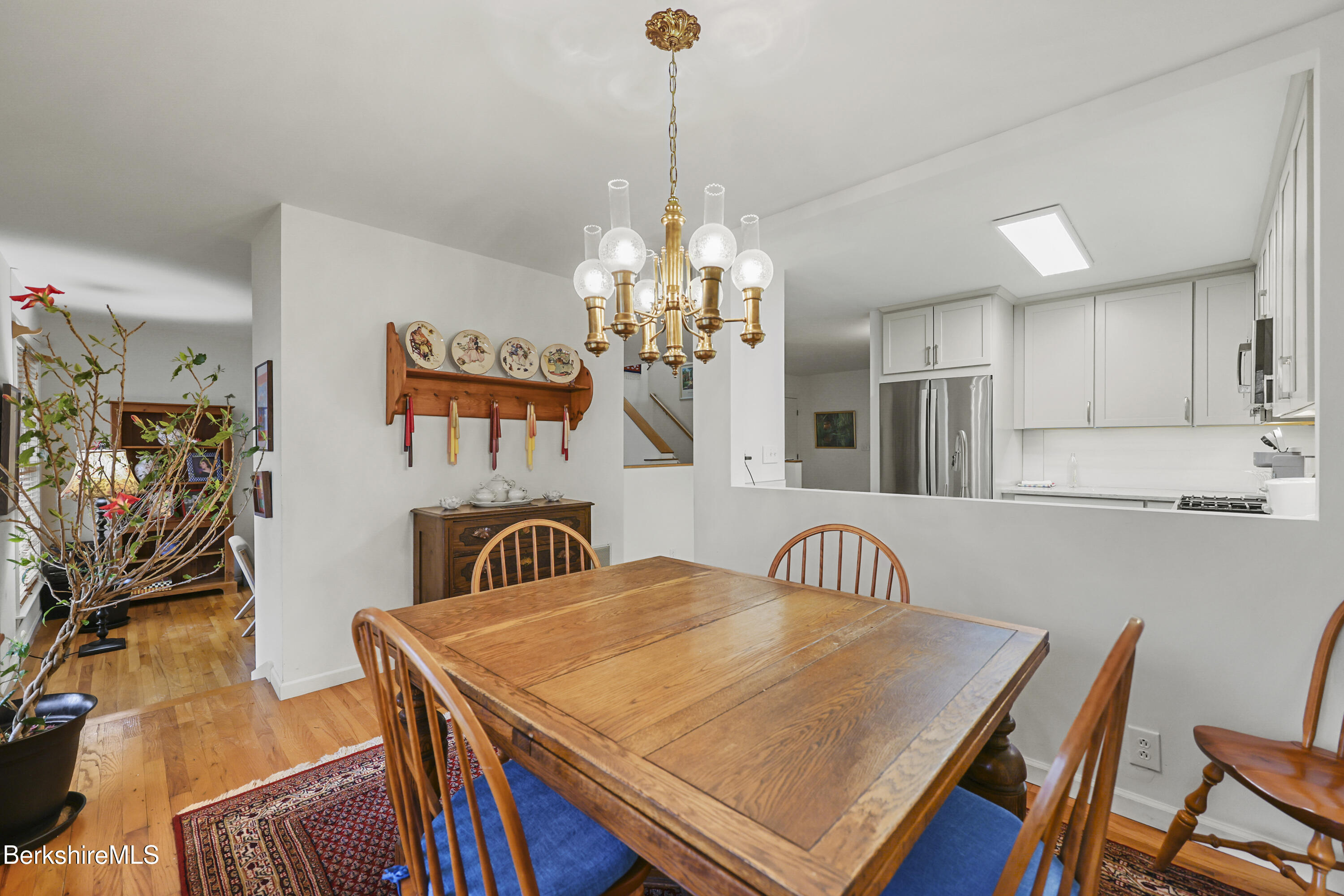 1136 Barker Road, Unit 27 Pittsfield, MA 01201 - Photo 8 of 30 a view of a dining room with furniture and a chandelier