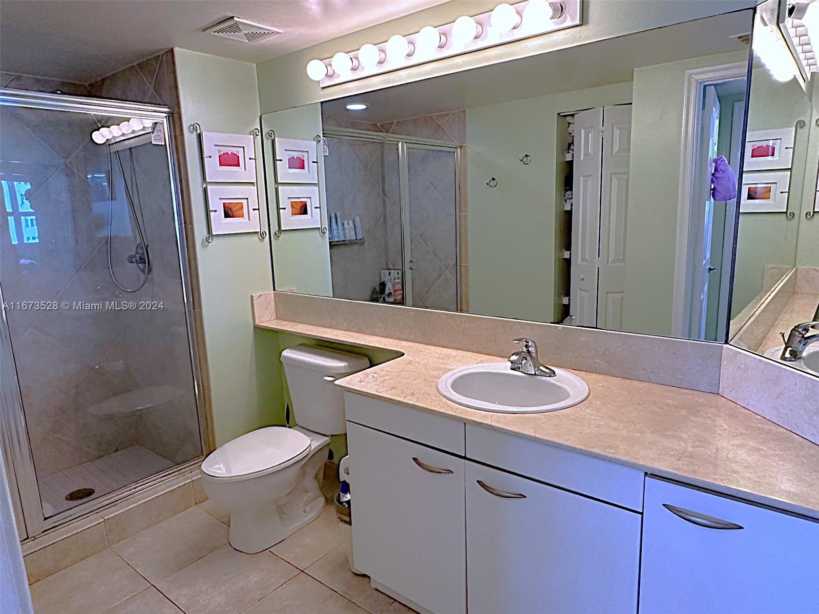 2080 South Ocean Drive, Unit 1602 Hallandale Beach, FL 33009 - Photo 13 of 38 a bathroom with a sink a toilet and shower