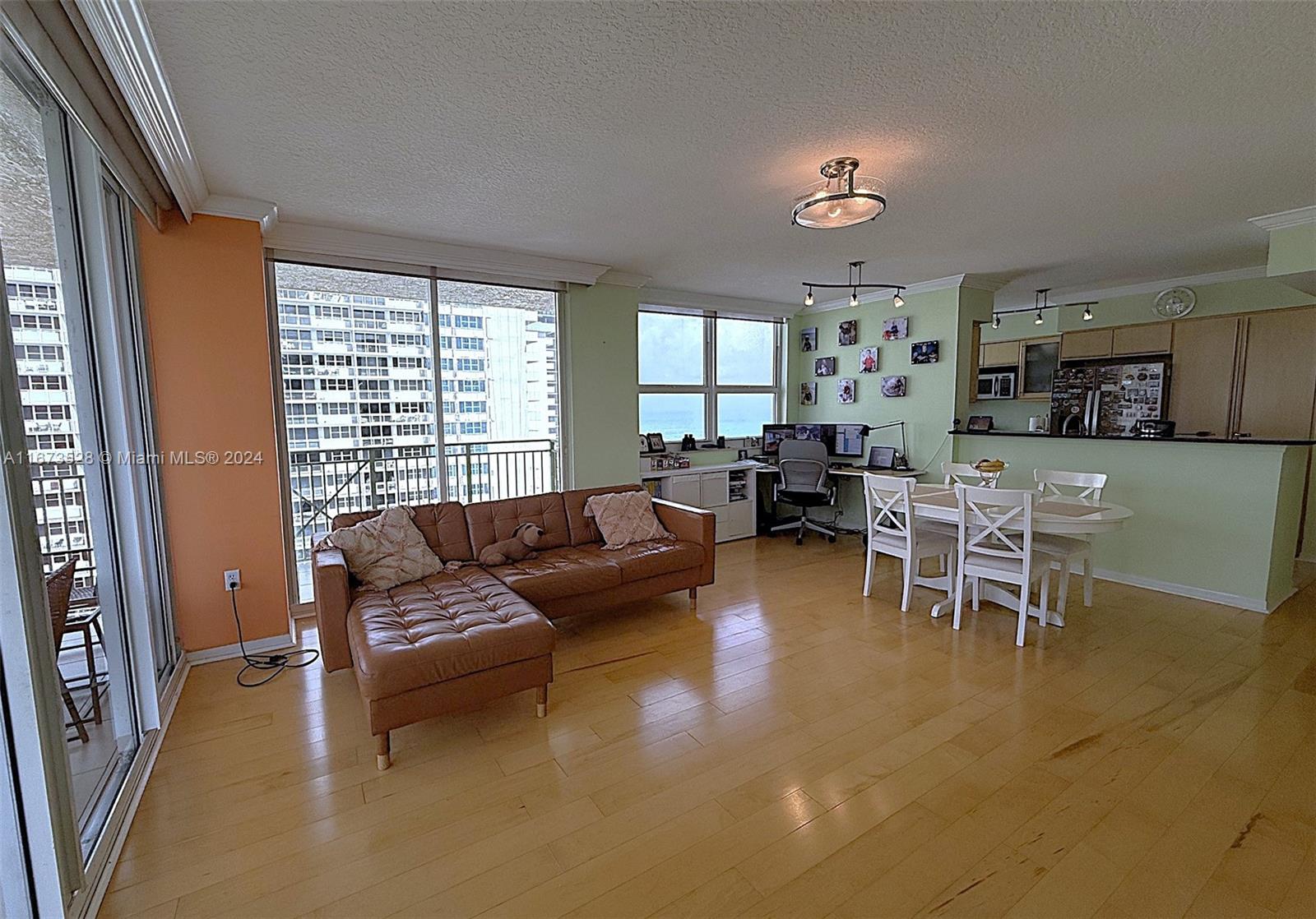 2080 South Ocean Drive, Unit 1602 Hallandale Beach, FL 33009 - Photo 2 of 38 a living room with furniture and a large window