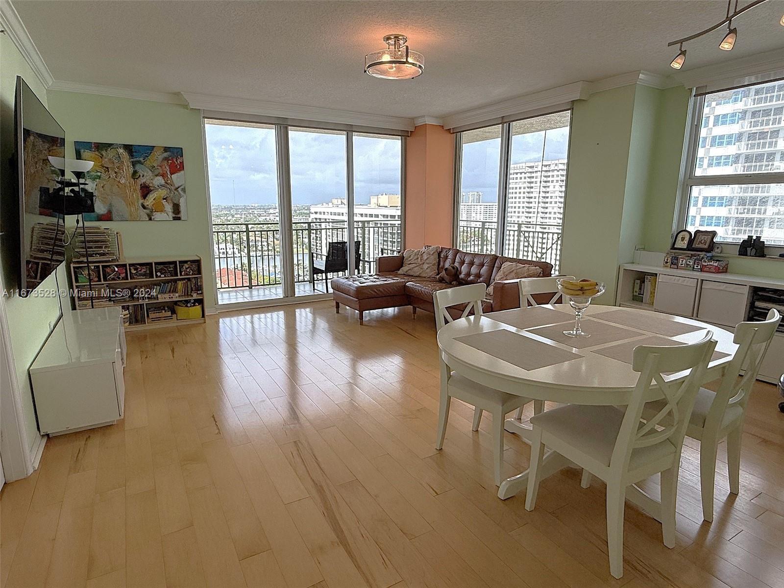 2080 South Ocean Drive, Unit 1602 Hallandale Beach, FL 33009 - Photo 3 of 38 a living room with fireplace furniture and a large window