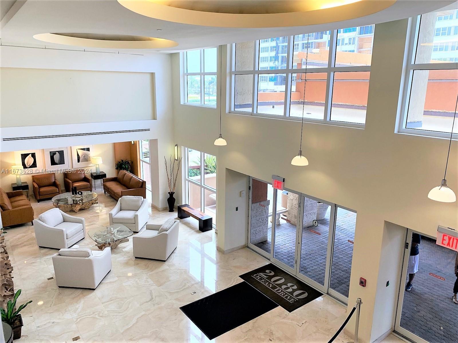 2080 South Ocean Drive, Unit 1602 Hallandale Beach, FL 33009 - Photo 33 of 38 a living room with furniture and floor to ceiling windows