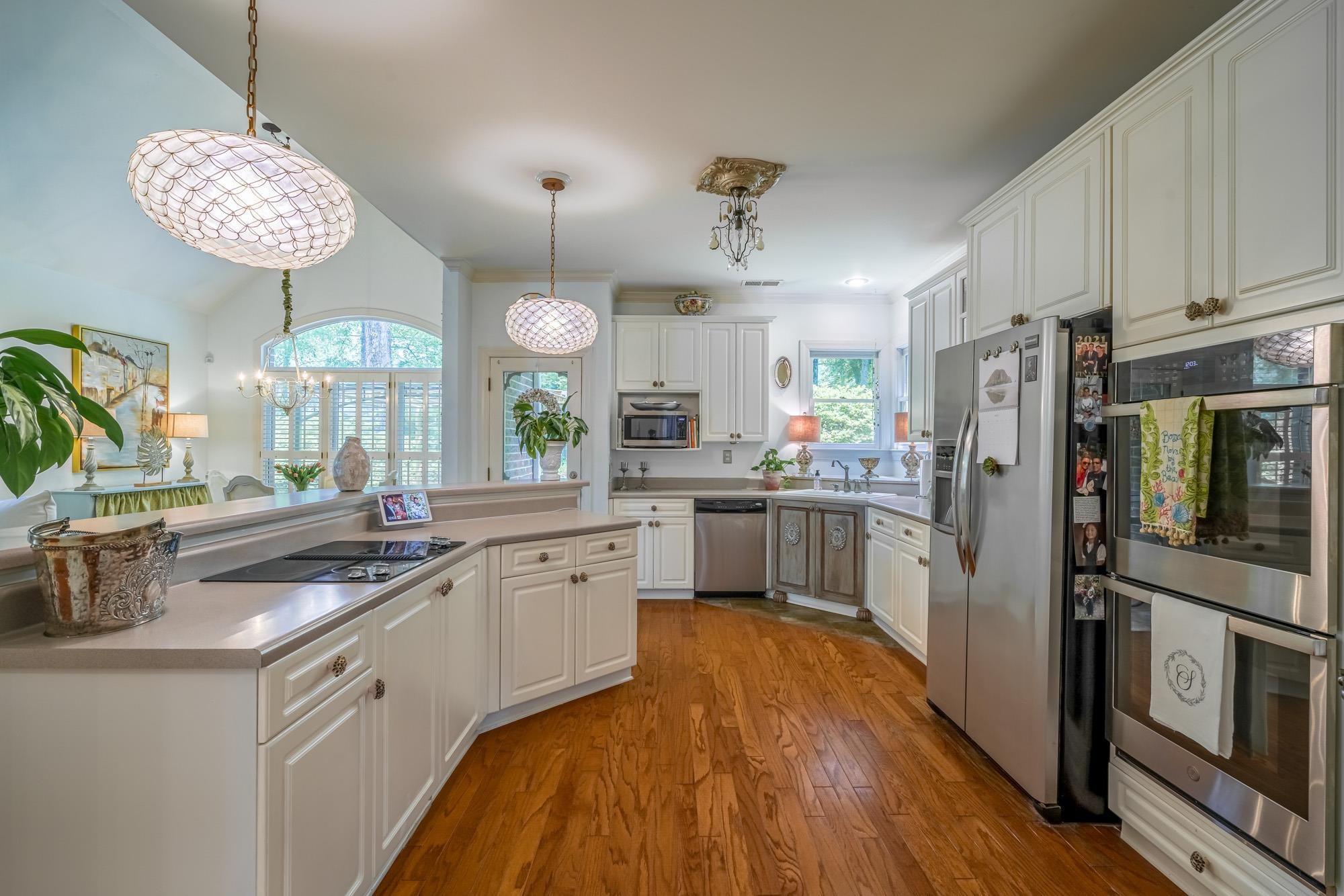 490 Brook Ridge Circle Memphis, TN 38018 - Photo 9 of 25 a kitchen with a sink stainless steel appliances and chandelier
