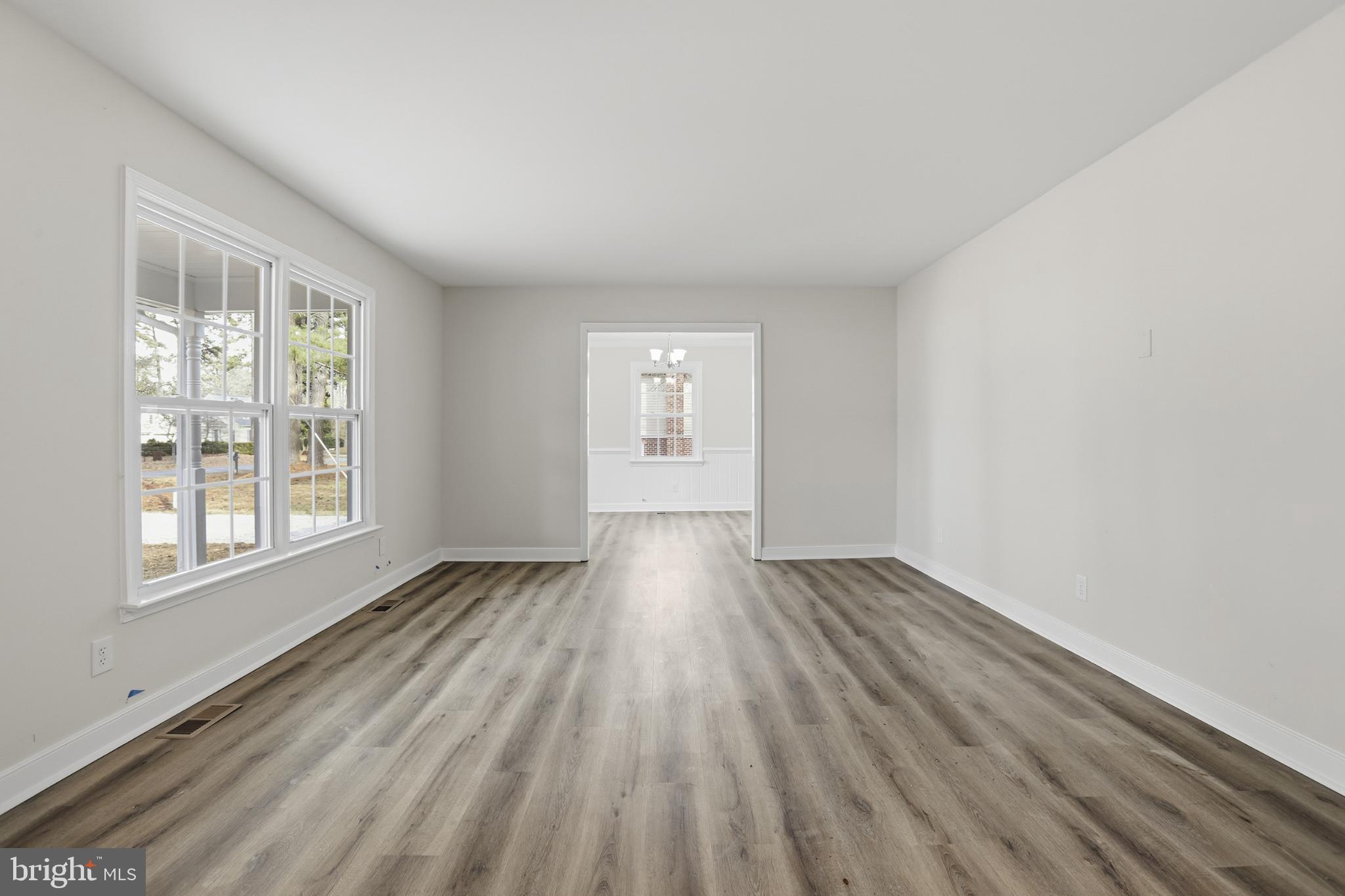 192 East Banbury Road Tappahannock, VA 22560 - Photo 12 of 50 an empty room with wooden floor and windows