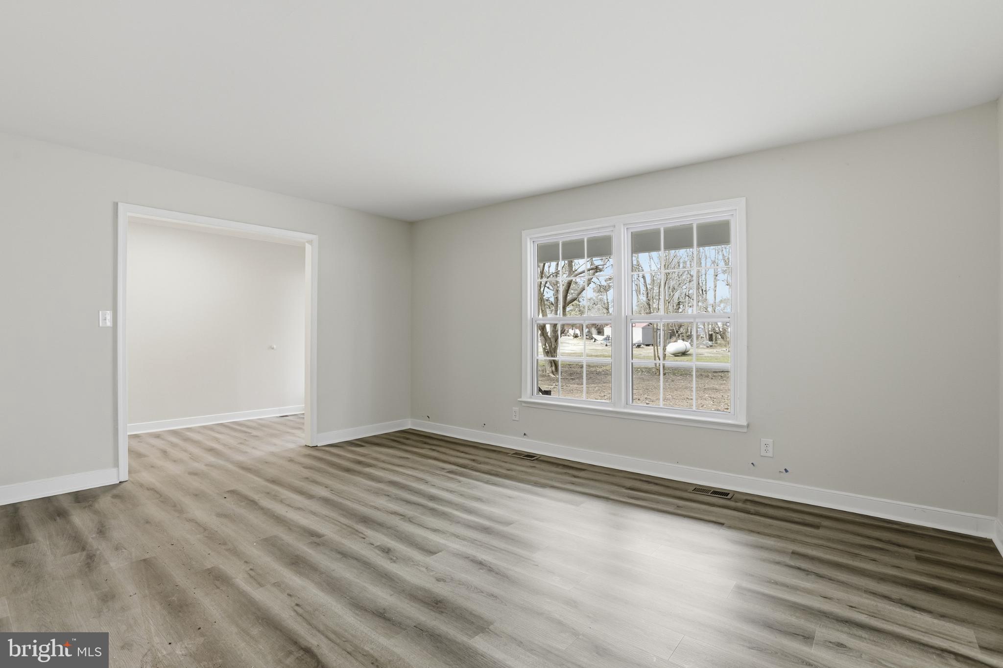 192 East Banbury Road Tappahannock, VA 22560 - Photo 14 of 50 an empty room with wooden floor and windows