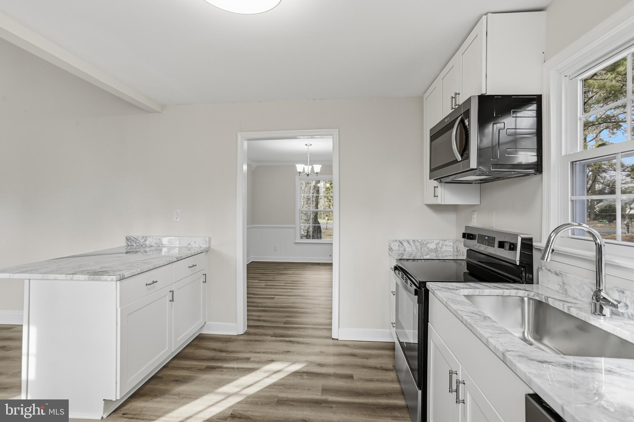 192 East Banbury Road Tappahannock, VA 22560 - Photo 22 of 50 a kitchen with stainless steel appliances granite countertop a sink and a stove top oven