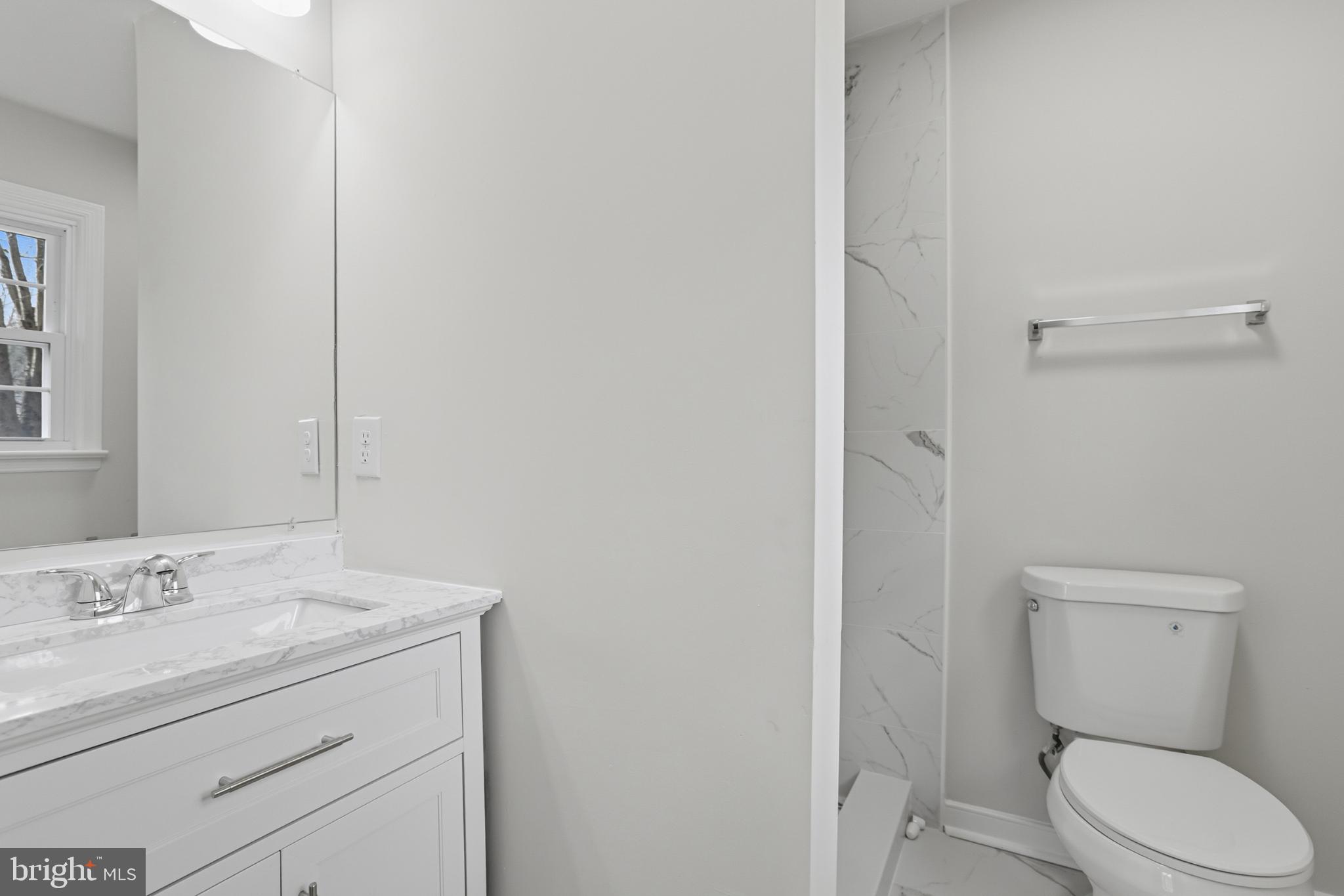 192 East Banbury Road Tappahannock, VA 22560 - Photo 29 of 50 a bathroom with a granite countertop toilet sink and mirror