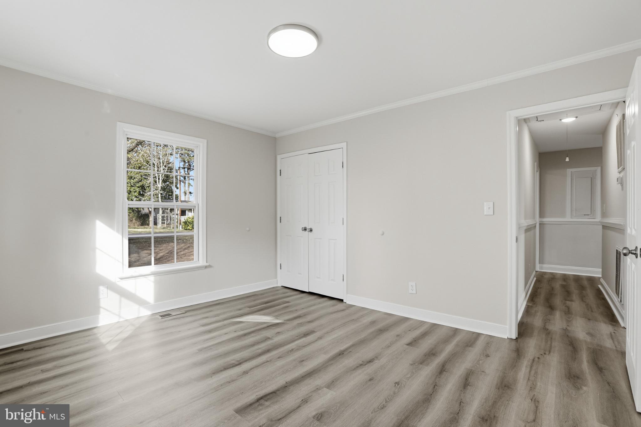 192 East Banbury Road Tappahannock, VA 22560 - Photo 36 of 50 an empty room with wooden floor and windows