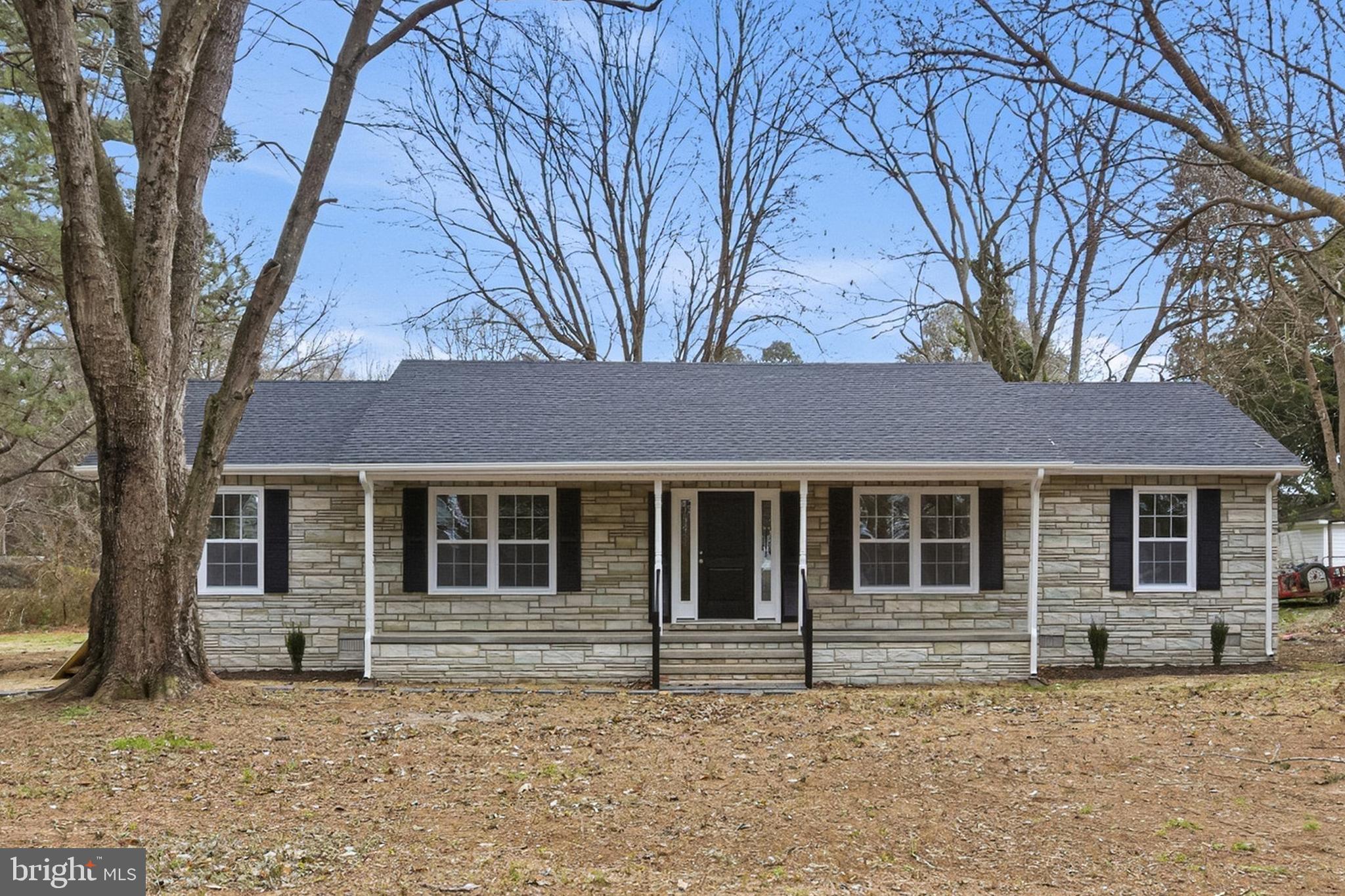 192 East Banbury Road Tappahannock, VA 22560 - Photo 7 of 50 a house with trees in the background