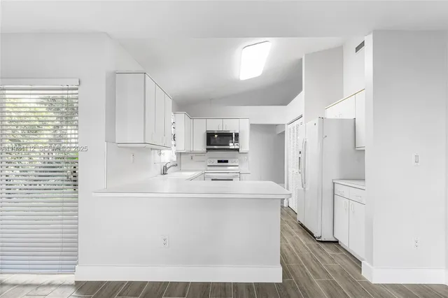 a kitchen with stainless steel appliances a refrigerator sink and cabinets