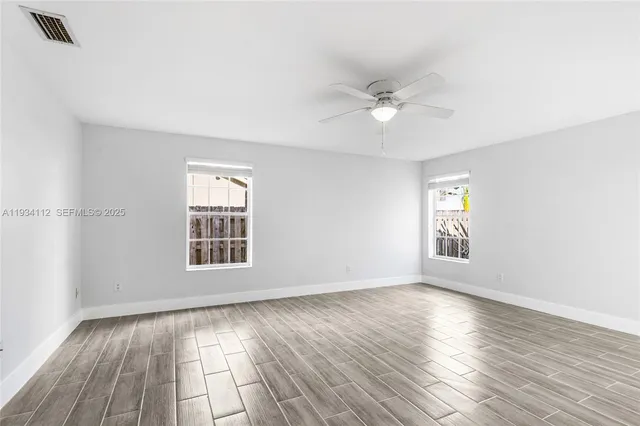 wooden floor in an empty room with a window