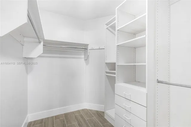 a view of walk in closet with empty racks