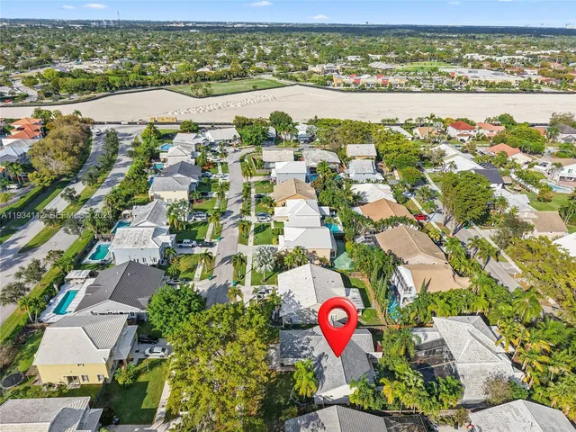 an aerial view of residential houses with outdoor space and river
