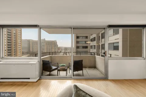 a living room with furniture and a floor to ceiling window