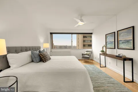 a bedroom with a large bed and a large window