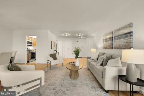 a living room with furniture and a lamp