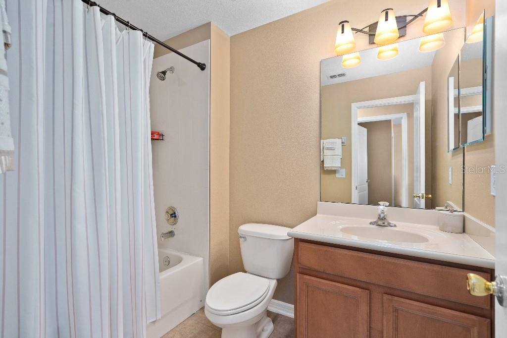 2417 Passamonte Drive, Unit 1E Winter Park, FL 32792 - Photo 13 of 15 a bathroom with a sink vanity mirror and toilet