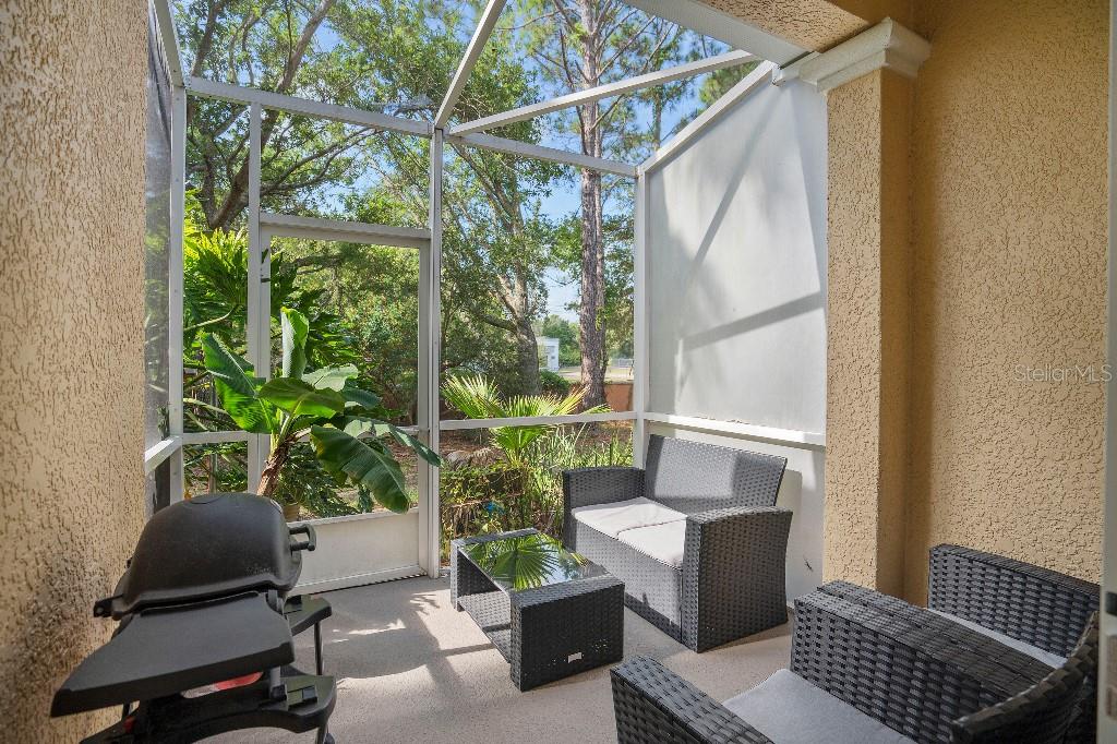 2417 Passamonte Drive, Unit 1E Winter Park, FL 32792 - Photo 14 of 15 a patio with table and chairs and potted plants