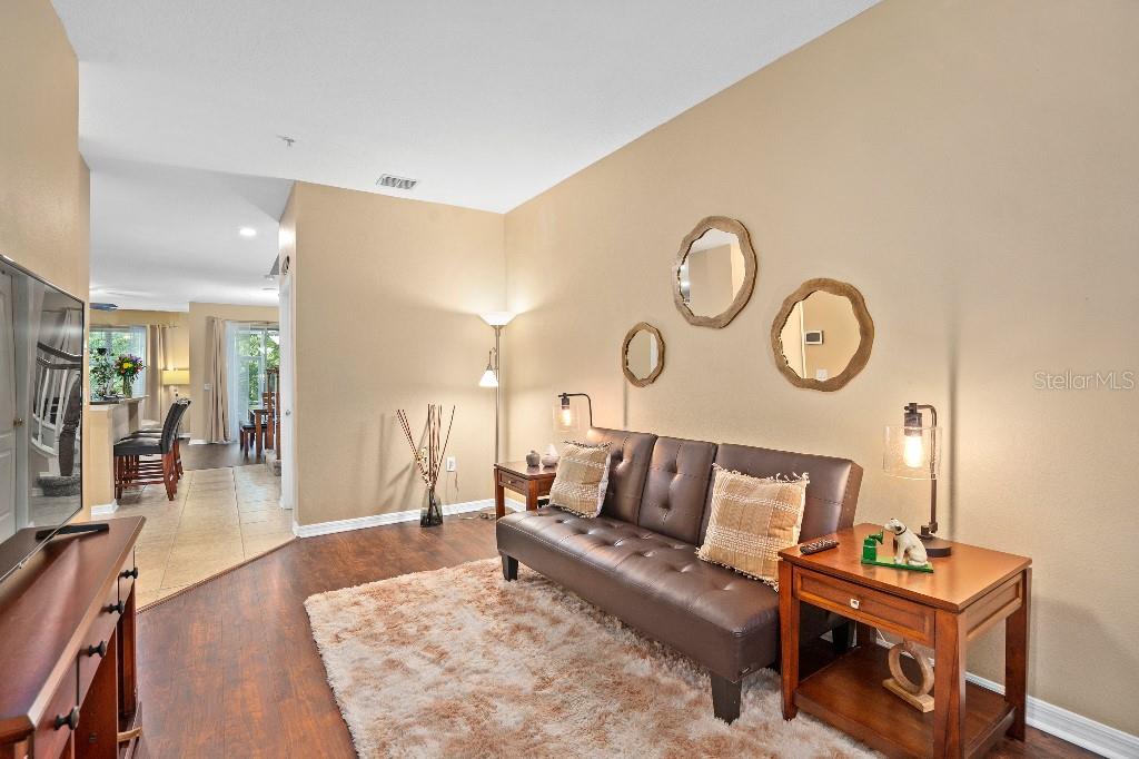2417 Passamonte Drive, Unit 1E Winter Park, FL 32792 - Photo 2 of 15 a living room with furniture and wooden floor