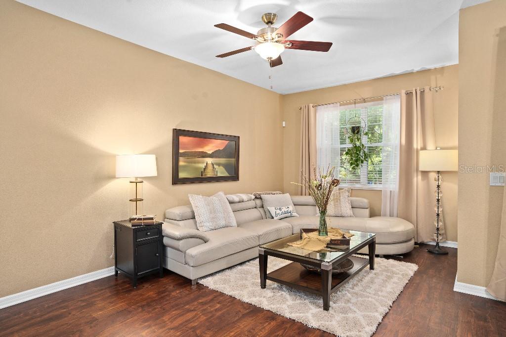 2417 Passamonte Drive, Unit 1E Winter Park, FL 32792 - Photo 4 of 15 a living room with furniture and a large window