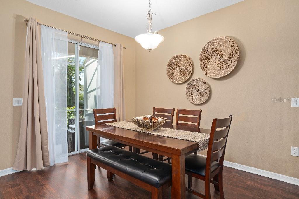 2417 Passamonte Drive, Unit 1E Winter Park, FL 32792 - Photo 5 of 15 a view of a dining room with furniture window and wooden floor