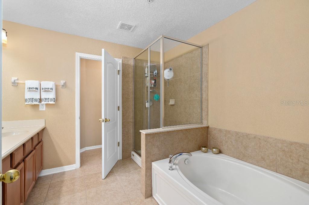 2417 Passamonte Drive, Unit 1E Winter Park, FL 32792 - Photo 10 of 15 a bathroom with a bathtub and a shower