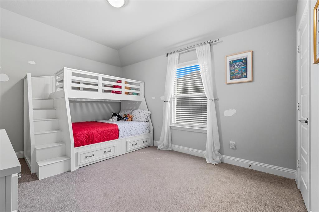 8492 Chapote Road Frisco, TX 75035 - Photo 24 of 40 Secondary Bedroom features vaulted ceiling with flush-mount light. Spacious layout with soft carpet flooring extending through the space.