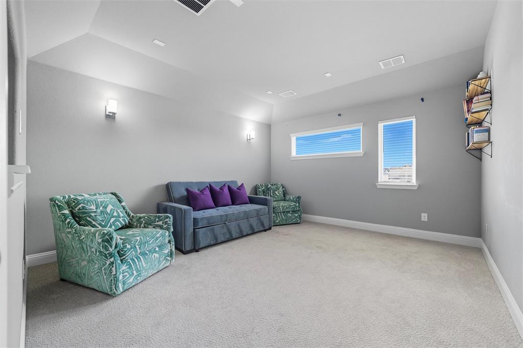 8492 Chapote Road Frisco, TX 75035 - Photo 25 of 40 Media Room features vaulted ceiling with recessed lighting and wall-mounted sconces. Soft carpet flooring extending through the space.