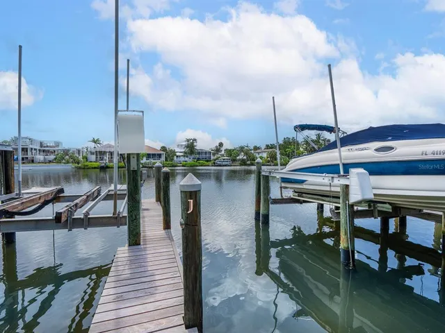 an aerial view of residential houses with outdoor space and lake view